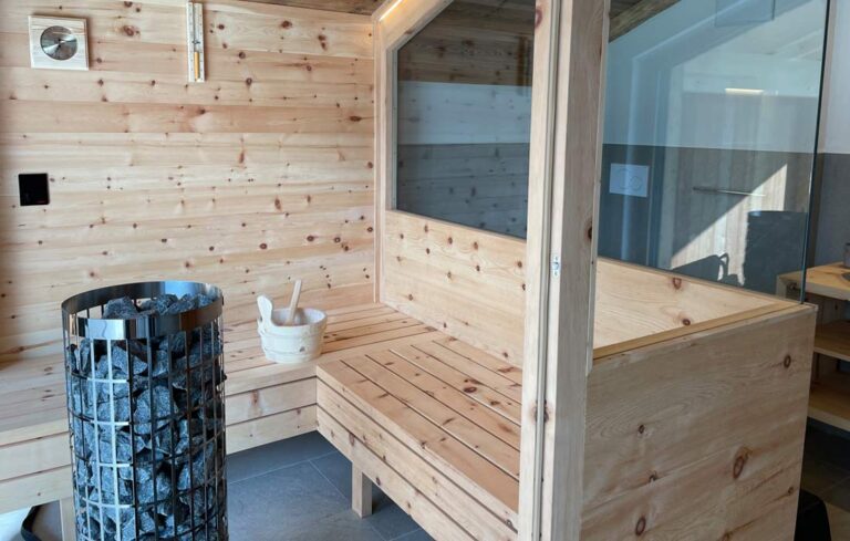 a wooden sauna with a bucket and a bucket of sauna