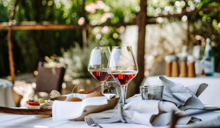 a table with wine glasses and food on it