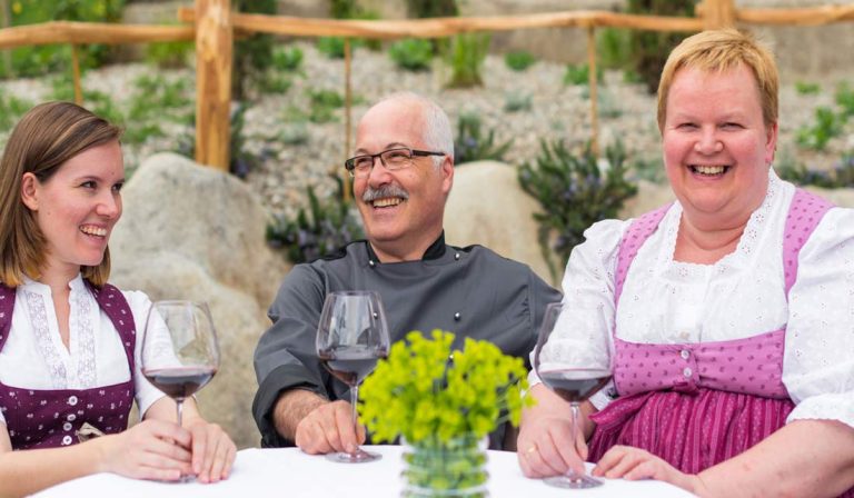 a group of people sitting at a table with wine glasses