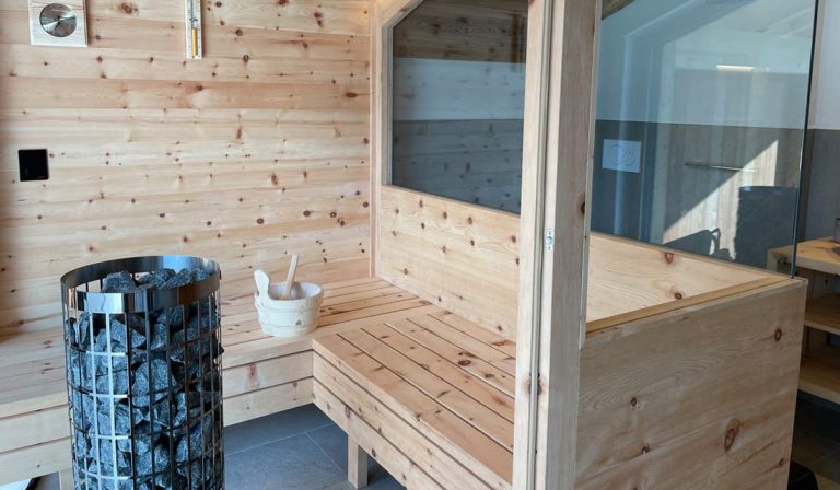 a wooden sauna with a bucket and a bucket of sauna